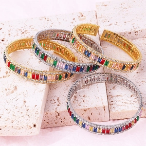 Detail of luxury gold and silver bangles with colorful rectangular zircon stones