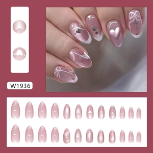 Pink cat eye press on nails with silver heart bow designs and French tips
