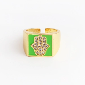 Detail of Hamsa Hand ring with green enamel and micro-set zircon on golden band