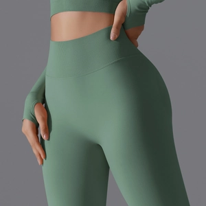Close-up of sage green seamless yoga leggings with high-waisted ribbed detailing