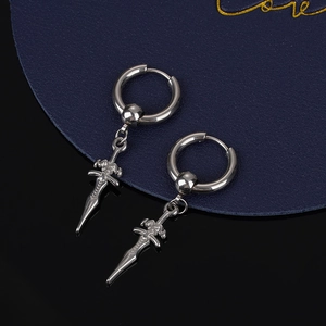 Silver stainless steel dagger pendant hoop earrings for men and women on a dark surface