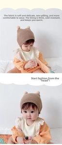 Detail of baby winter knit hat with cute pompoms and soft fleece lining for warmth