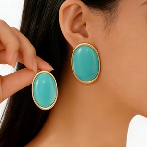 Vintage oversized oval resin earrings with gold metal trim in a bright turquoise hue