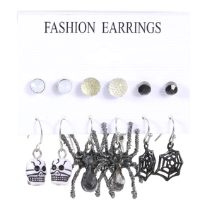 Halloween earring set featuring spooky skull, spider, and cobweb charms on a card