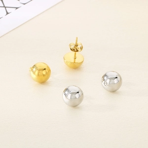 Polished half-sphere stud earrings in gold and silver finish with metallic surface