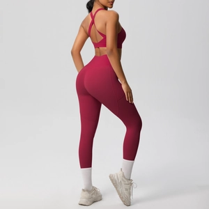 Detail of cross-back yoga bra and high-waisted leggings in deep red brushed fabric