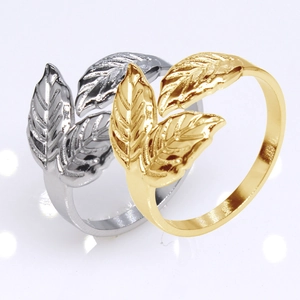 Macro shot of gold and silver leaf-shaped adjustable stainless steel open rings