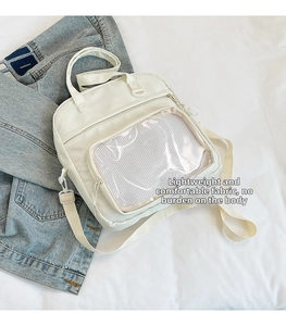 Detail of white tote bag featuring transparent display window and lightweight fabric