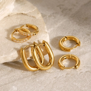 Three pairs of gold stainless steel hoop earrings with cubic zirconia stone accents