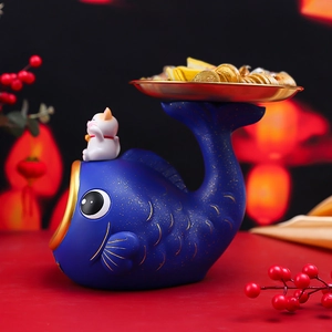 Macro view of blue koi fish storage tray with lucky cat and golden ingots detail
