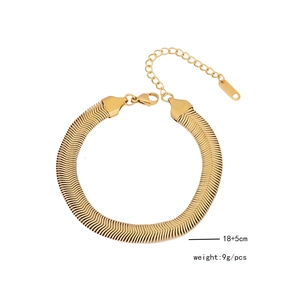 Detail of golden snake bone chain bracelet with lobster clasp and extension link