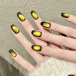 Amber gold gradient cat eye press-on nails with starburst sparkle on medium square oval tips