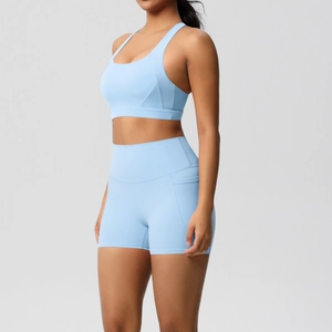 Detail view of high-waist yoga shorts with functional side pockets in light blue