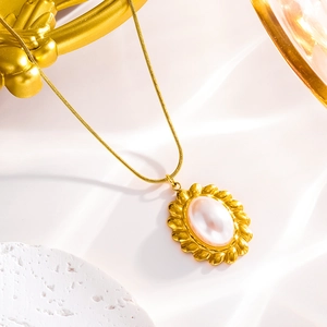 Detail of oval mother of pearl pendant with gold petal frame on thin snake chain