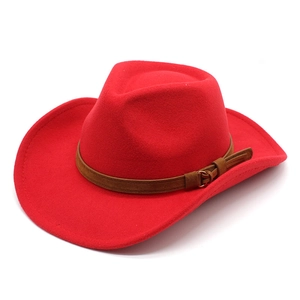 Detailed macro view of the red felt cowboy hat with its brown leather strap and metal buckle