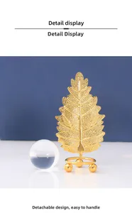 Detail view of gold metal leaf stand with detachable design and clear crystal sphere
