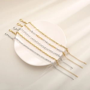 Set of 6 minimalist 18K gold and silver plated titanium steel anklets on a white plate