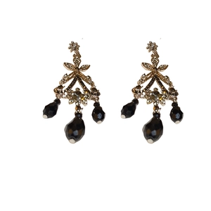 Vintage gold drop earrings featuring intricate filigree work and black teardrop beads