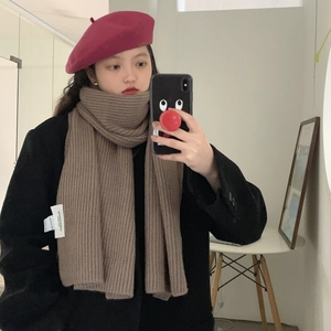 Thick ribbed knit brown scarf with white label, perfect for 2024 winter casual style