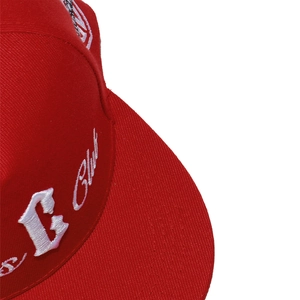 Detail of red flat brim cap with white 3D embroidery and twill cotton fabric texture