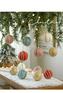 Close-up of glittery 8cm Christmas ball ornaments with pearls on a pine branch
