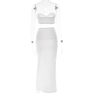 Detail view of a white two-piece set featuring a bandeau top and side slit maxi skirt