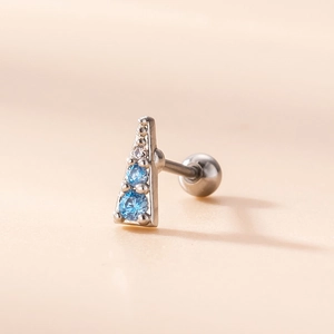 Detailed close-up of a triangle earring with blue and clear zircon stones and screw back
