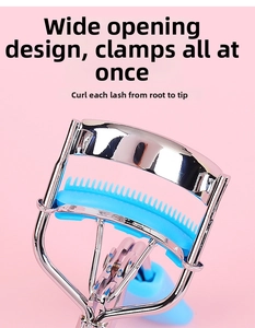 Macro view of portable stainless steel eyelash curler with light blue silicone comb pad