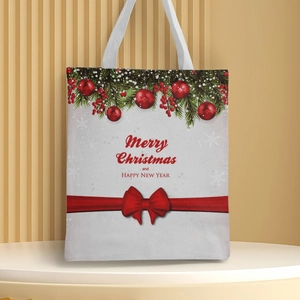 Detail of Christmas canvas handbag with pine branches, berries and red ribbon bow decor