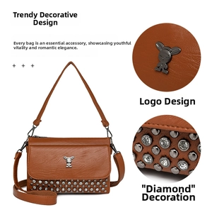 Detail of brown leather crossbody bag with silver rabbit logo and rhinestone stud accents