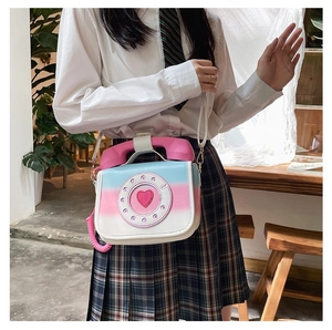Detail shot of a creative telephone shaped crossbody bag with pink blue gradient