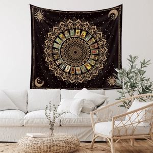 Detail of bohemian black and gold mandala sun moon tapestry with tarot illustrations