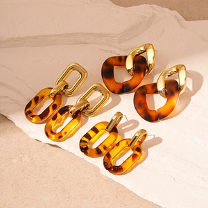 Three-pair set of vintage leopard print acrylic and gold metal geometric hoop earrings