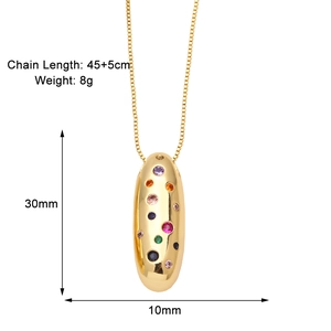 Detailed view of gold oval pendant necklace with colorful cubic zirconia and dimensions