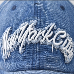 Vintage blue washed denim baseball cap with white New York City 3D embroidery and distressed patch