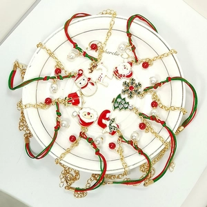 Close-up of Christmas charm bracelet with Santa, reindeer and snowflake pendants