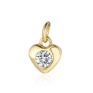 Detail of a golden heart pendant with a sparkling round-cut zircon center and metal bail