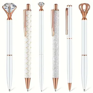 Detail view of 6 white and rose gold ballpoint pens with crown and diamond toppers