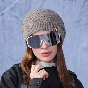Chic women's grey knit beanie with ear protection and hollow weave for winter warmth