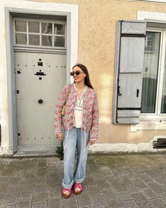 Detail of bohemian pink floral quilted jacket with tie-front closure and vintage style