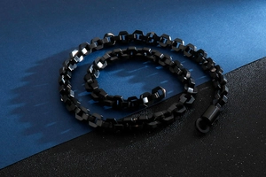 Macro shot of matte black hexagonal link chain with a round toggle clasp for men