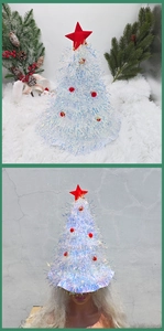Silver laser tinsel Christmas hat with red star topper and pom-poms on plush background