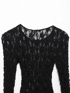 Close-up of intricate floral lace texture on this slim-fit long-sleeve black top