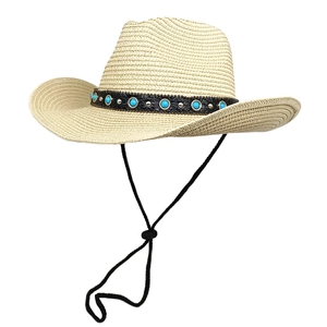 Detail of beige straw fedora featuring black leather band with blue beads and rivets