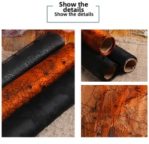 Detail of Halloween mesh roll featuring orange and black spider web and bat patterns