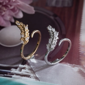 Elegant gold and silver feather open rings featuring micro-set cubic zirconia accents
