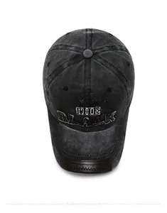 Detail of grey washed denim baseball cap with Original The Black embroidery and leather brim