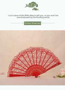 Detail of red lace folding fan with floral patterns and gold-stamped ribs on linen