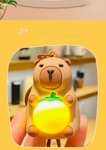 Glow-in-the-dark Capybara bag pendant with warm light and a glowing orange detail
