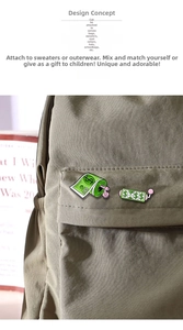 Cartoon dollar bill enamel pins displayed on a green canvas backpack for styling
